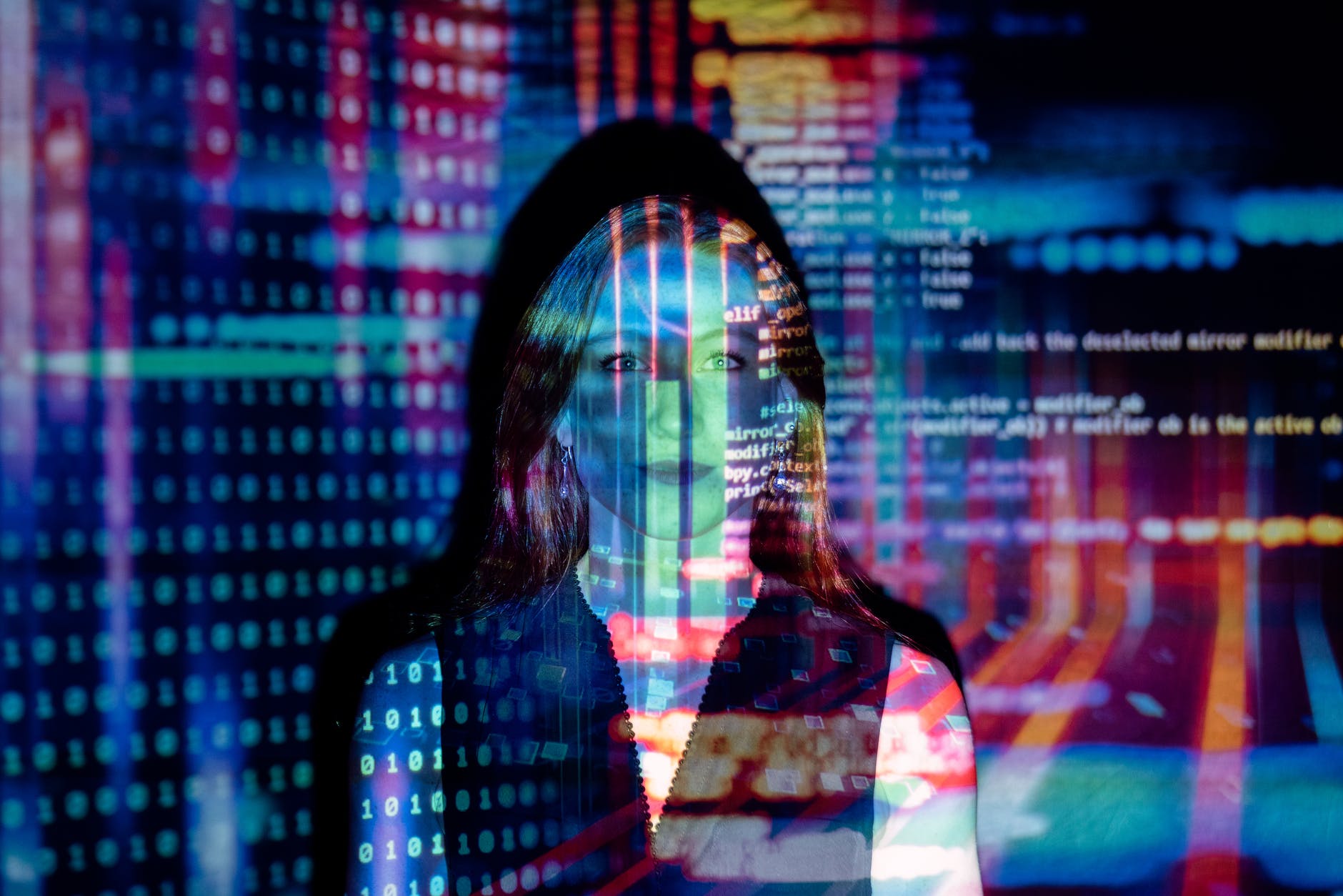 Photo of code projected over a woman
