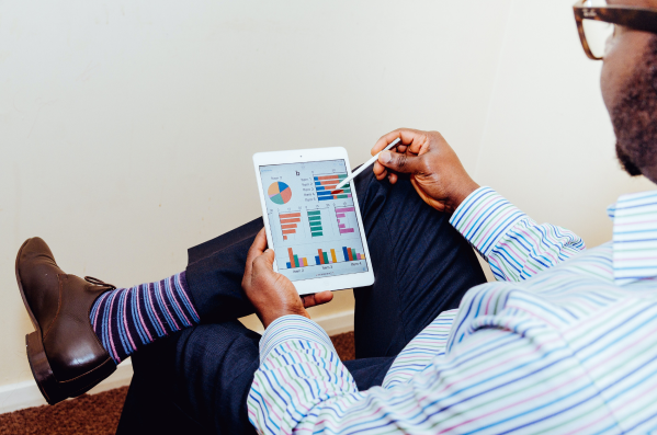Businessman looking at his accounts receivable analysis on a tablet.